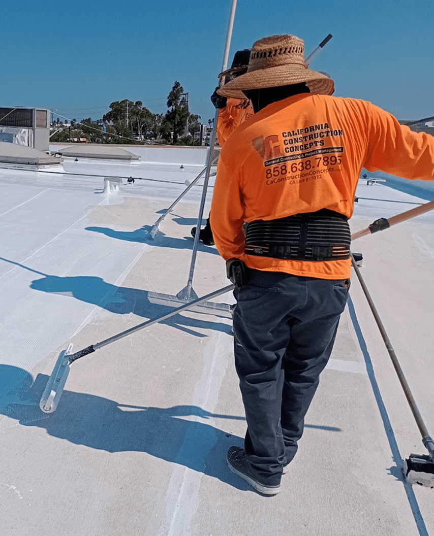 Man in hat working on building roof