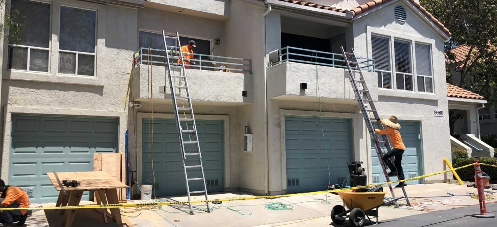 Workers renovating residential building exterior