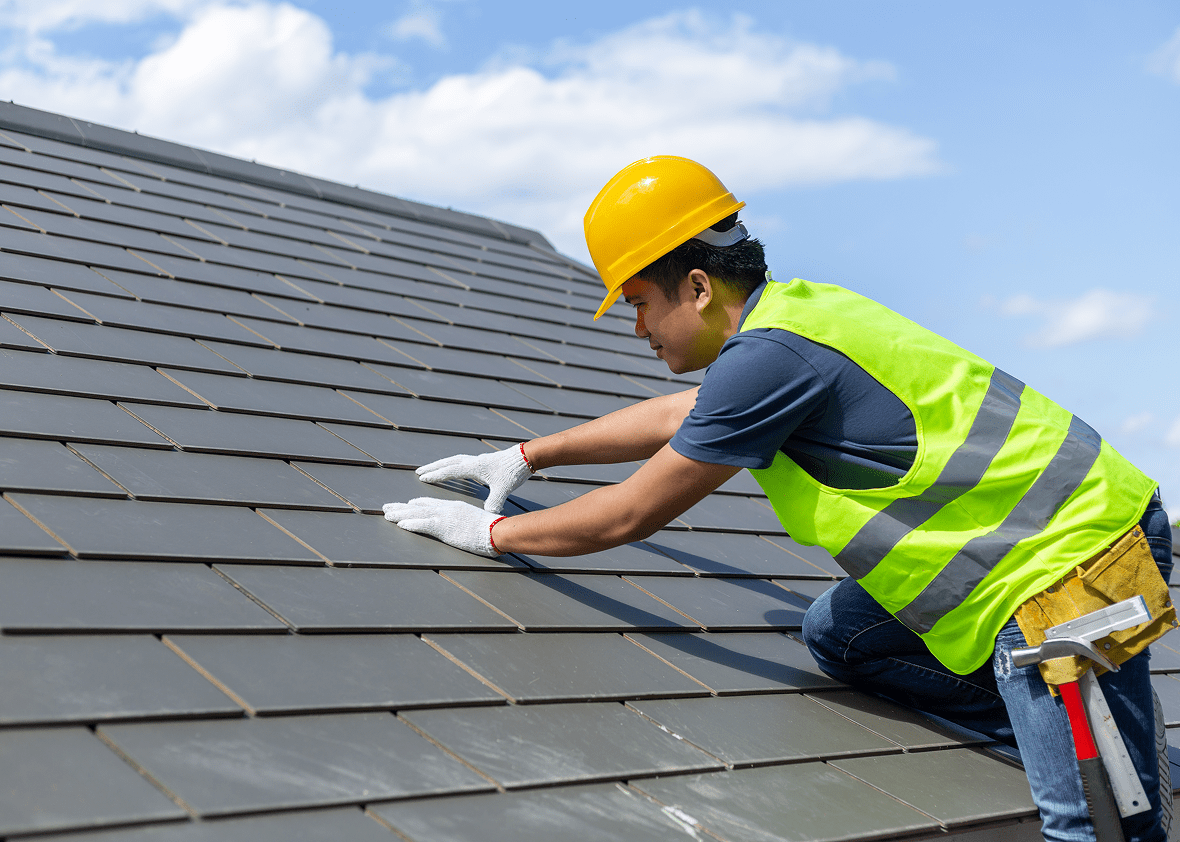 Construction worker on roof with safety gear